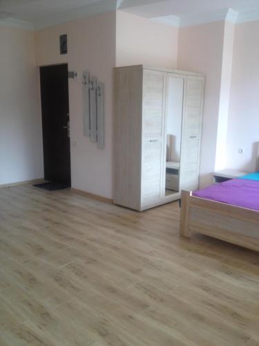a bedroom with a bed and a dresser and a mirror at Nodari in Batumi