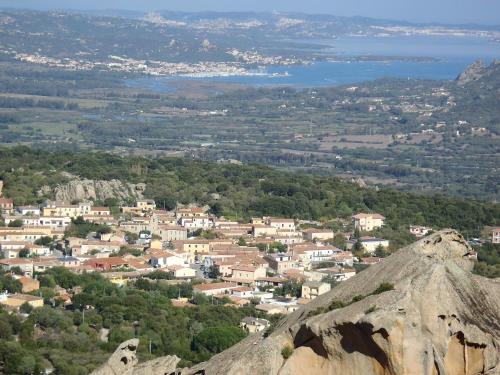 a view of a town from the top of a mountain at Boutique Hotel Sant'Andrea & Relais in San Pantaleo