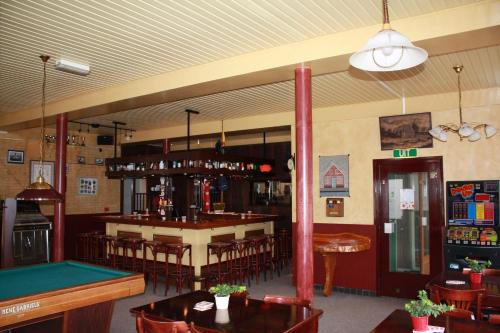 a restaurant with a pool table and a bar at Hotel 't Meertje in Vinkeveen