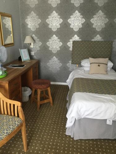 A bed or beds in a room at The Haymaker Inn 