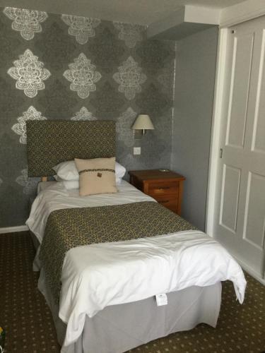 a bedroom with a bed with a pillow on it at The Haymaker Inn in Chard