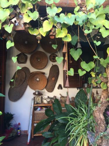 a room with a bunch of hats hanging from a wall at L'Onda in Oristano
