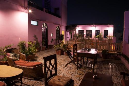 a patio with a table and chairs and a building at Kanhaia Haveli in Pushkar