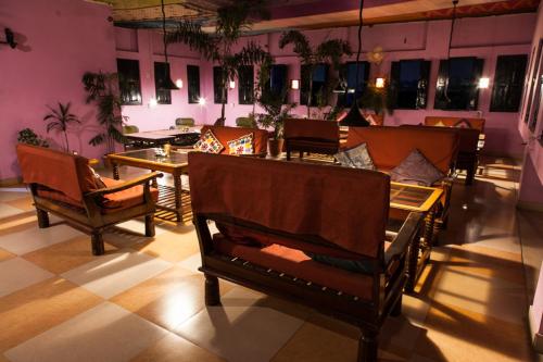a room with chairs and a couch and a table at Kanhaia Haveli in Pushkar