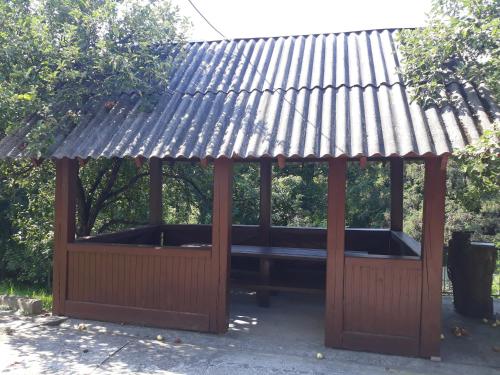 a wooden gazebo with a tin roof at Котедж "Лісовий затишок" in Glubokoye