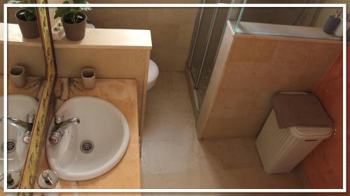 a bathroom with a sink and a toilet at Casa Las Toro Playa in Chilches