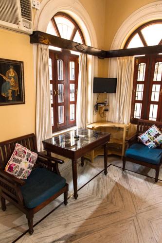 a living room with a table and two chairs at Kanhaia Haveli in Pushkar