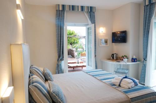 a bedroom with a bed and a door to a patio at Villa Carlotta Minori in Minori