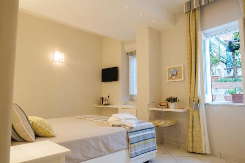 a bedroom with a bed and a window at Villa Carlotta Minori in Minori