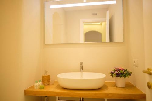 a bathroom with a large white sink and a mirror at Villa Carlotta Minori in Minori