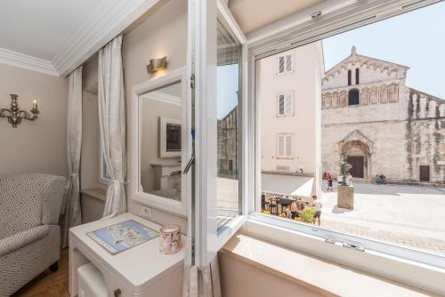 a room with a window with a view of a church at Accommodation Piazzetta Marina in Zadar