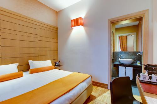 a hotel room with a bed and a sink at Solo Experience Hotel in Florence