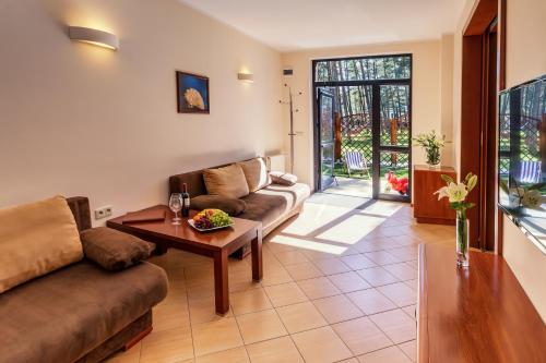 a living room with a couch and a table at Columbus Rowy in Rowy
