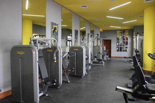 a gym with a row of treadmills and machines at Radisson Blu Hotel, Abu Dhabi Yas Island in Abu Dhabi
