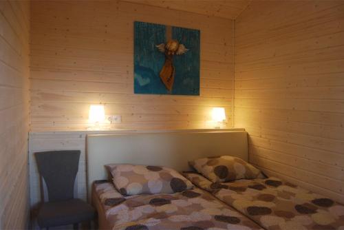 a room with a bed and a chair in a sauna at Uzenabow in Wicie