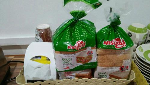 two bags of food in a basket on a table at Tamruethai House - ตามฤทัยเฮาส์ in Chiang Mai