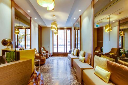 a lobby of a hotel with couches and chairs at Solo Experience Hotel in Florence