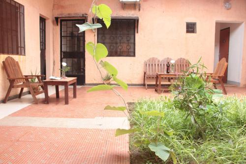 a patio with two chairs and a table and chairs at Ouaka in Ouagadougou