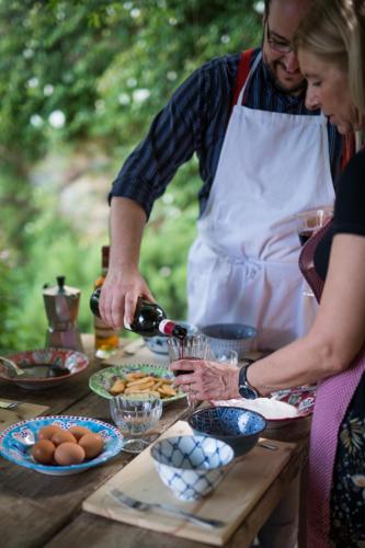 a man and woman preparing food on a table at La Canonica Di Nusenna in Gaiole in Chianti