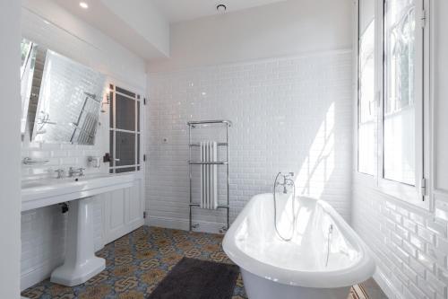 une salle de bain blanche avec une baignoire et un lavabo dans l'établissement Villa centre ville proche plage, à Nice