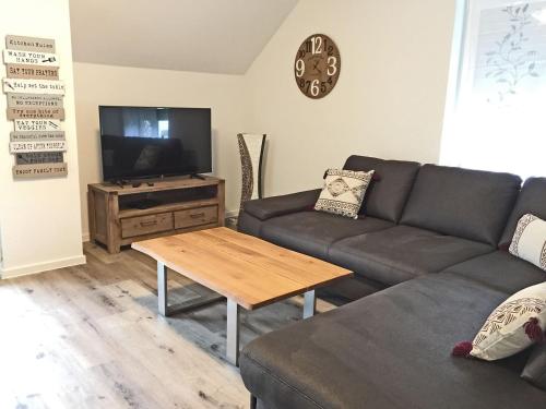 a living room with a couch and a table at Haus Josef Klotten Wohnung 2 in Klotten