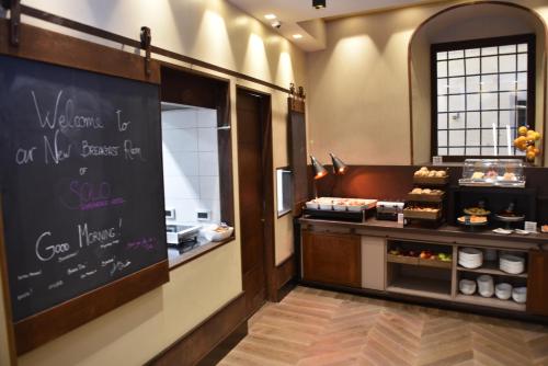 a bakery with a chalk board on the wall at Solo Experience Hotel in Florence