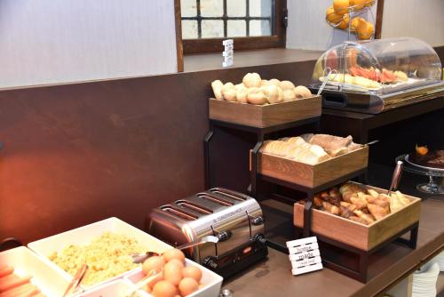 a buffet with various types of food on a counter at Solo Experience Hotel in Florence