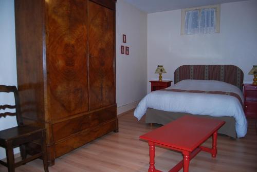En eller flere senger på et rom på Gîtes Le Tokay et Le Muscat