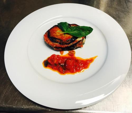 a white plate with a piece of food on it at Hotel Rodella in Selva di Val Gardena