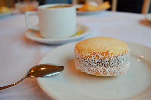 a piece of cake on a white plate with a spoon at Argentino Hotel Casino & Resort in Piriápolis