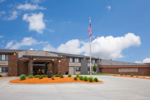 a building with an american flag in front of it at Carrollton Hotel in Carroll