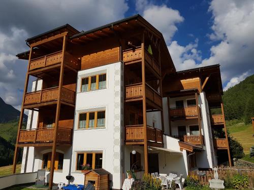 a large building with wooden balconies on it at Apart-Garni Motnaida in Samnaun