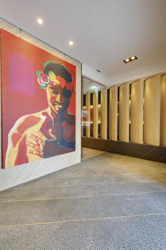 a large painting on the wall of a locker room at Hub Hotel Zhongli in Zhongli
