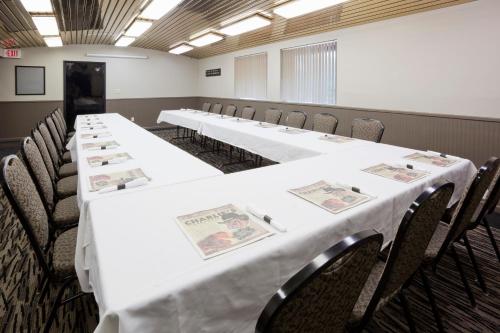 a row of tables in a room with chairs at Carrollton Hotel in Carroll