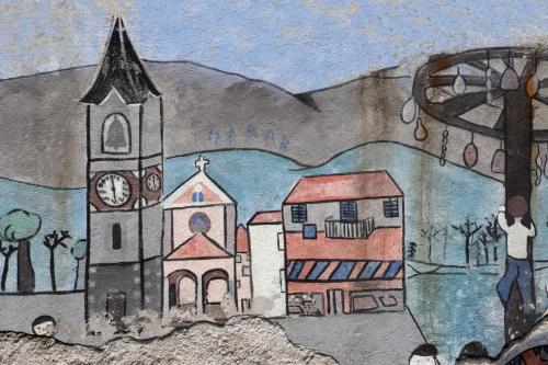 a drawing of a church with a man standing next to it at Appartamento Cristina in Stresa