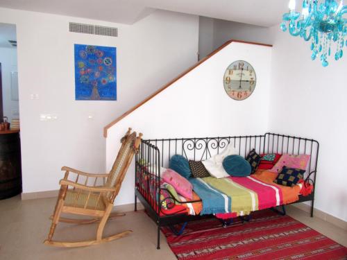 a crib in a room with a chair at Single room in private house el rompido in El Rompido