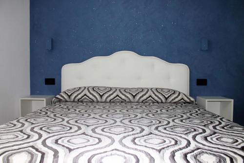 a bed with a white bedspread and pillows at B&B Porta Marina in Grottammare