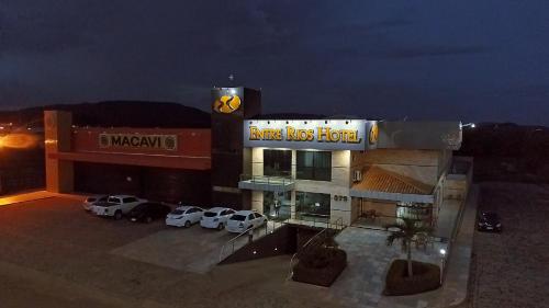 a building with cars parked in front of it at Entre Rios Hotel in Picos