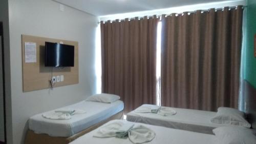 A bed or beds in a room at Entre Rios Hotel