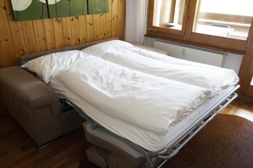 a hospital bed in a room with a window at Monte Rosa D 412 in Täsch