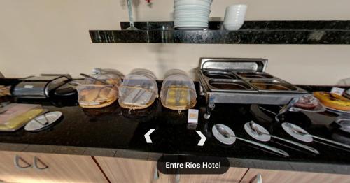 a counter with a group of shoes and a stove at Entre Rios Hotel in Picos
