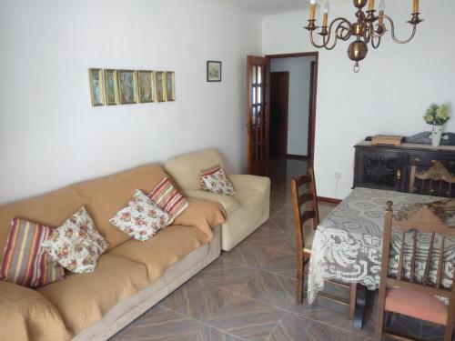a living room with a couch and a table at Apartamento Soares in Vila do Conde