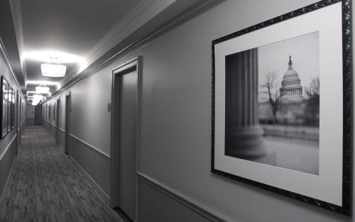a hallway with a framed picture of the capitol building at State Plaza Hotel in Washington