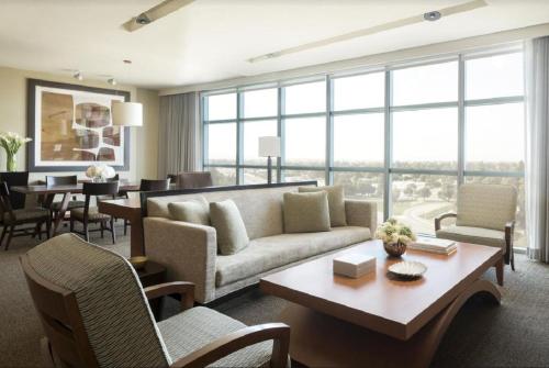 a living room with a couch and a table at Four Seasons Hotel Silicon Valley at East Palo Alto in Palo Alto