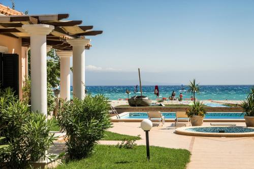 a resort with a view of the beach and the ocean at Aktes villas in Vasiliki