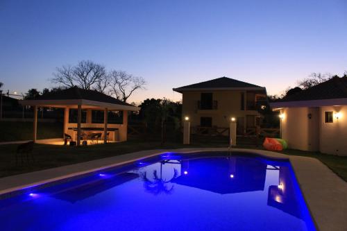 a swimming pool with blue lights in a backyard at Pocri Country Resort in Aguadulce