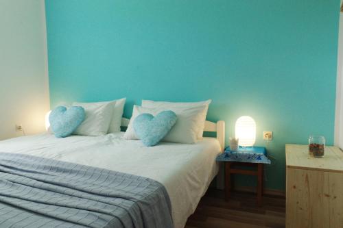 a bedroom with a white bed with blue walls at Apartment Vista in Tolmin