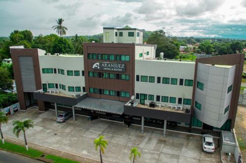 a building with a parking lot in front of it at Aranjuez Hotel & Suites in David