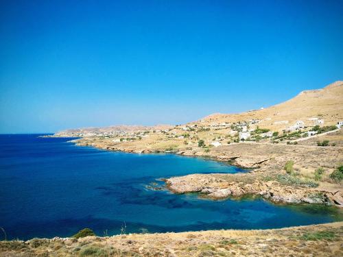 a view of a body of water on a hill at Litus Studios Syros in Megas Yialos-Nites