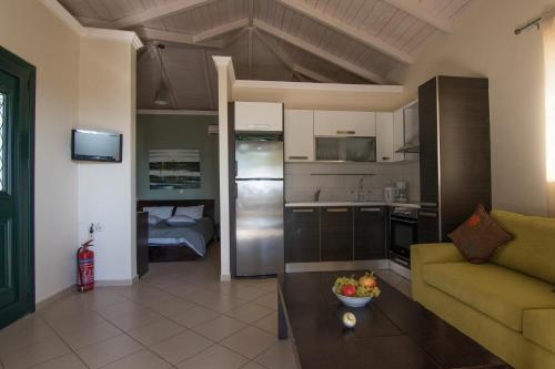 a kitchen and living room with a couch and a table at Aktes villas in Vasiliki